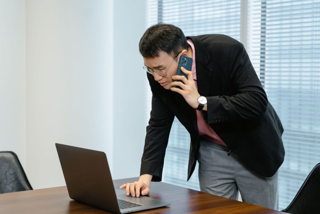 Medewerker belt zakelijk vanaf zijn laptop